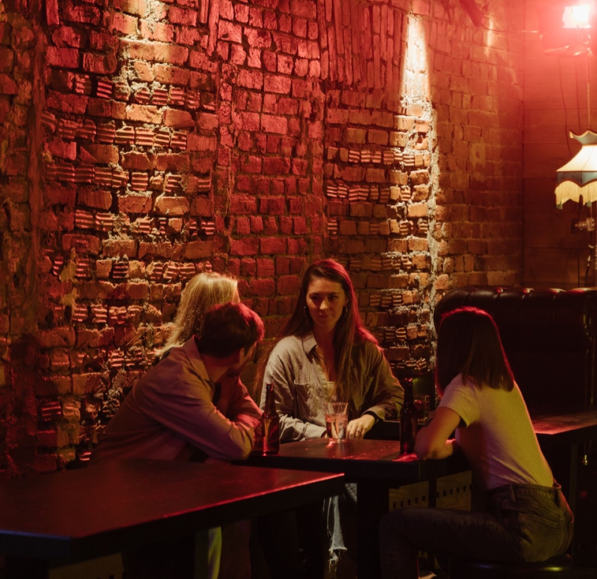 Friends talking over drinks in a Shoreditch bar